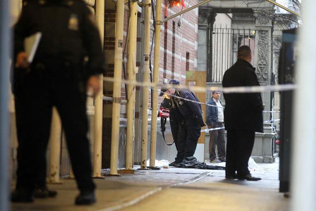 Police examine the scene of the fatal shooting on West 58th Street